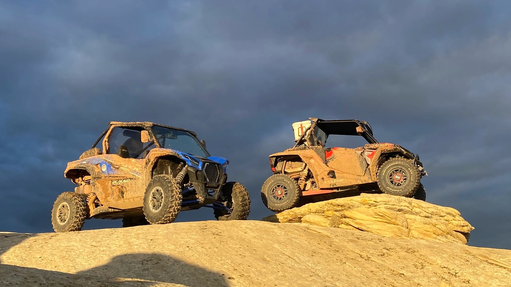 Mud-covered side-by-side UTVs on slickrock after a guided tour near Vernal Utah