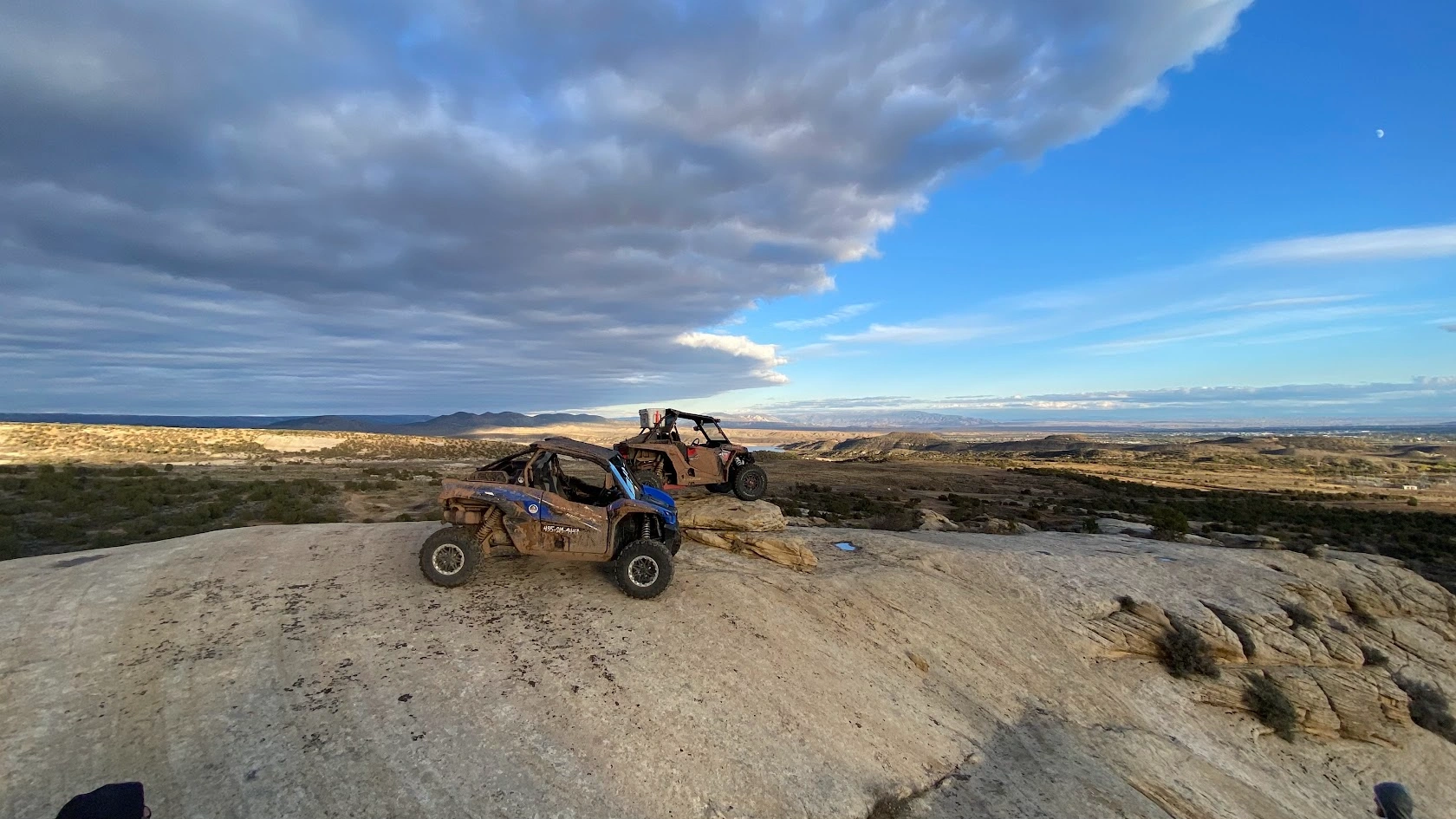 Side-by-side UTVs on a ridgetop at dusk near Vernal Utah