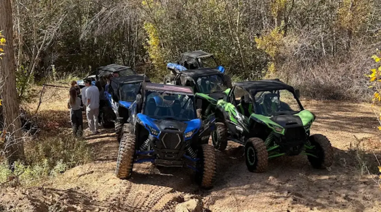 Group riding side-by-side UTVs on a backcountry trail near Vernal Utah