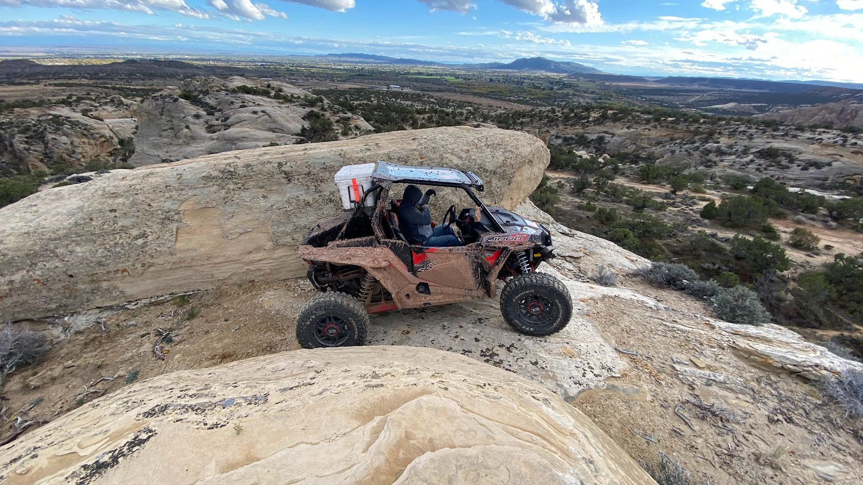 Side-by-side UTV climbing the slickrock on a guided tour near Vernal Utah