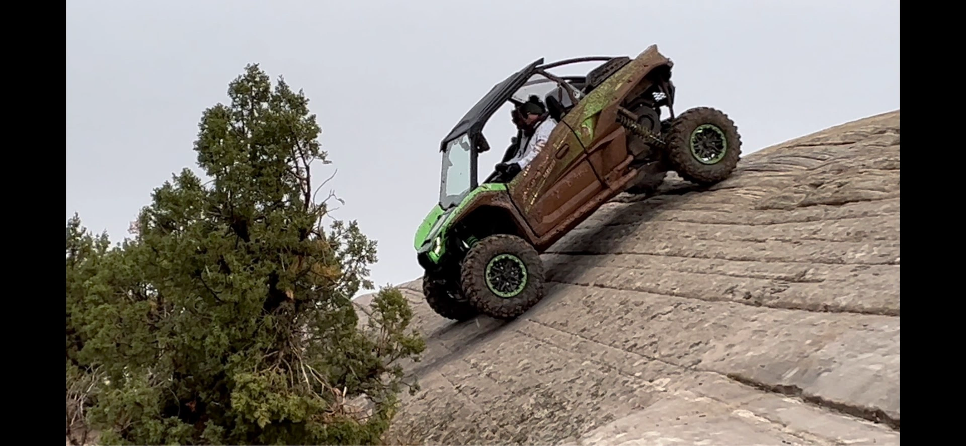 Side-by-side UTV on a steep slickrock descent near Vernal Utah