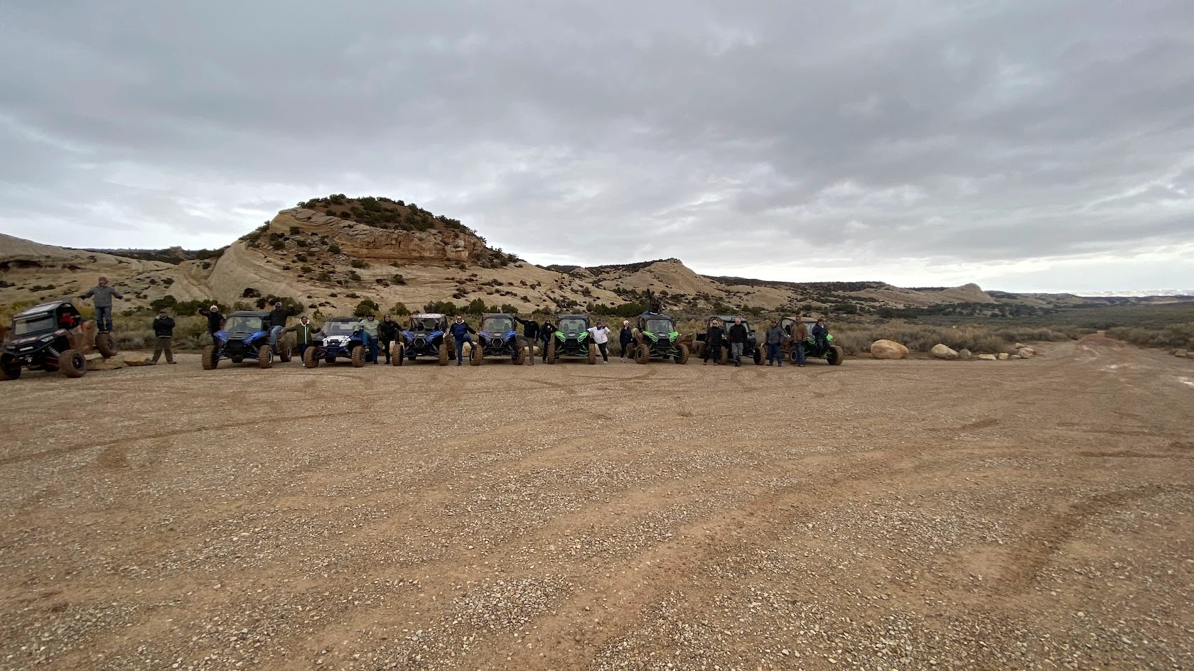 Long line of side-by-side UTVs staged and ready for a guided tour near Vernal Utah
