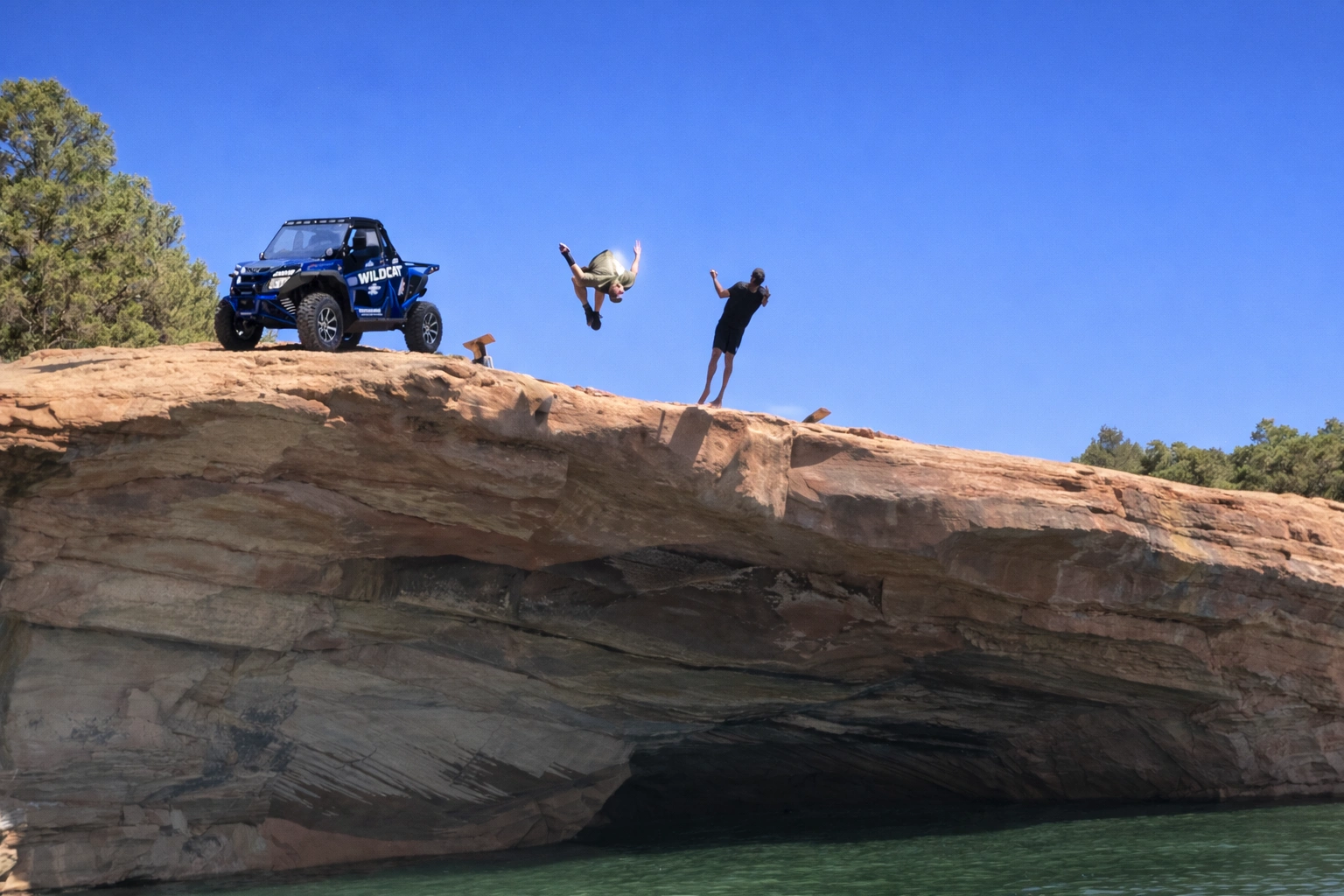 Rider jumping off a cliff for a cool-down on an Adventure Tours Vernal outing near Vernal Utah