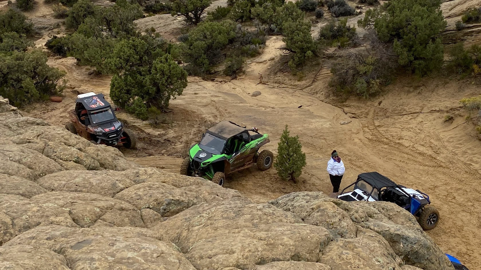 Three side-by-side UTVs rock crawling through the Utah backcountry