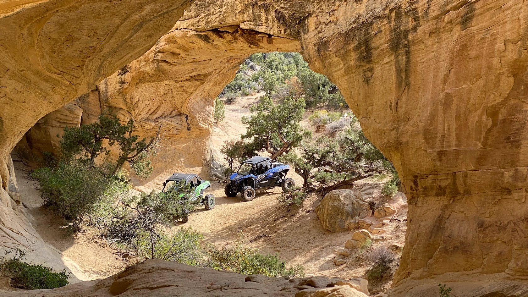 View through a sandstone arch on an Adventure Tours Vernal tour near Vernal Utah