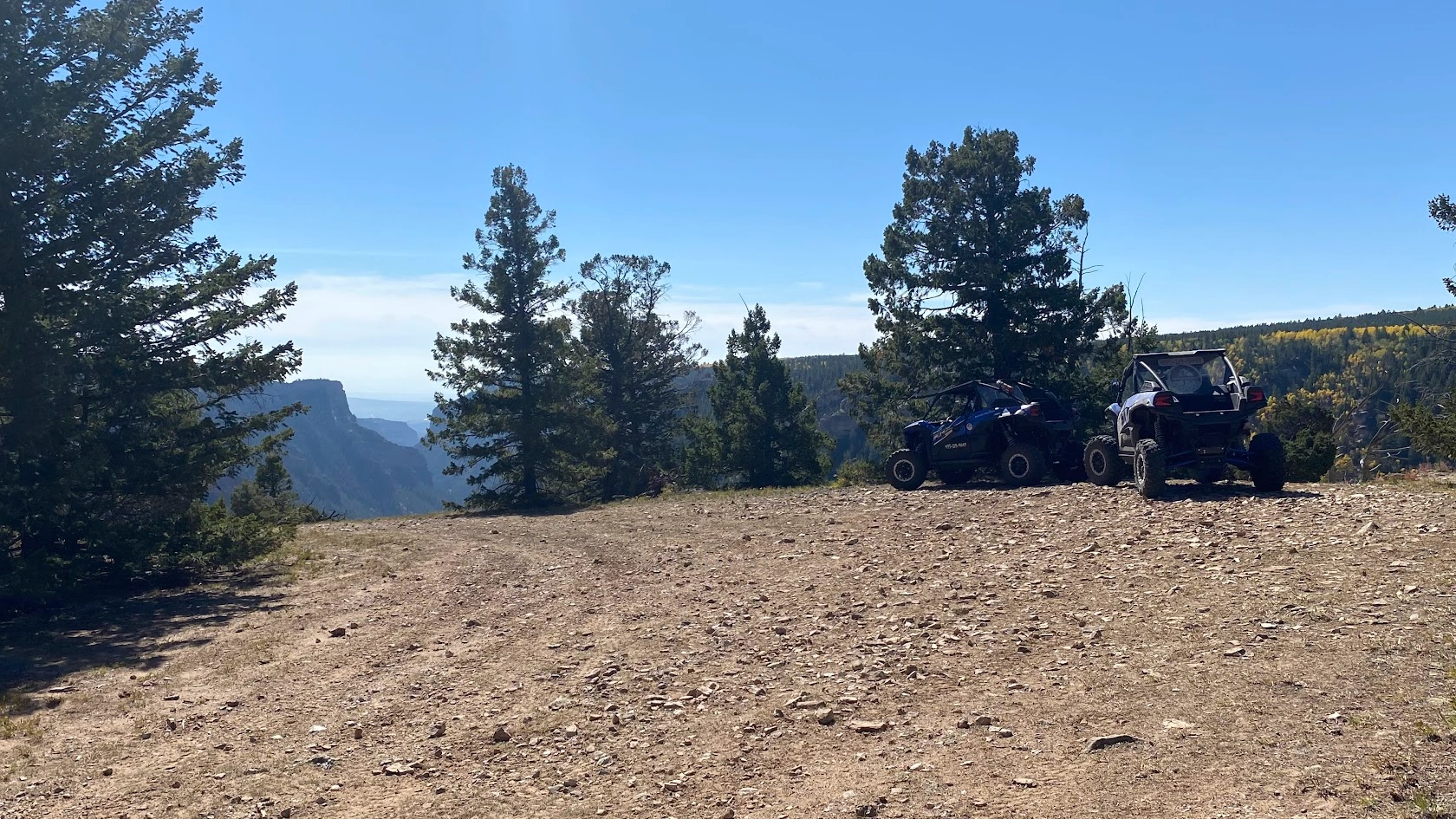 Side-by-side UTVs at a mountaintop staging point near Vernal Utah