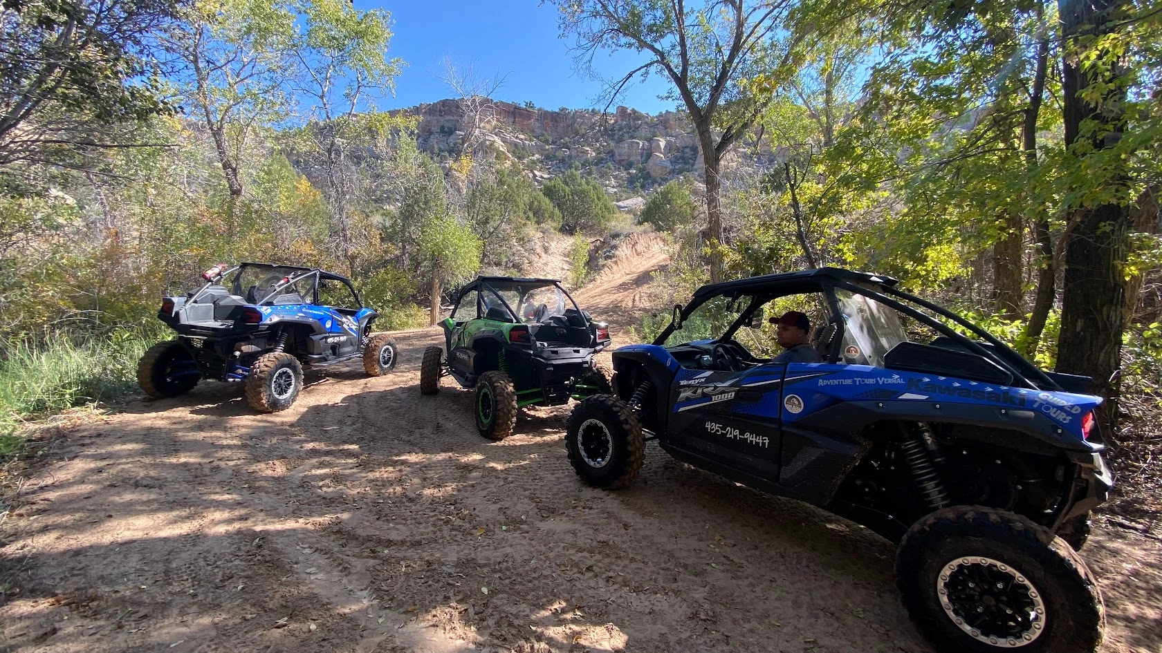 Three side-by-side UTVs lined up on a guided tour near Vernal Utah