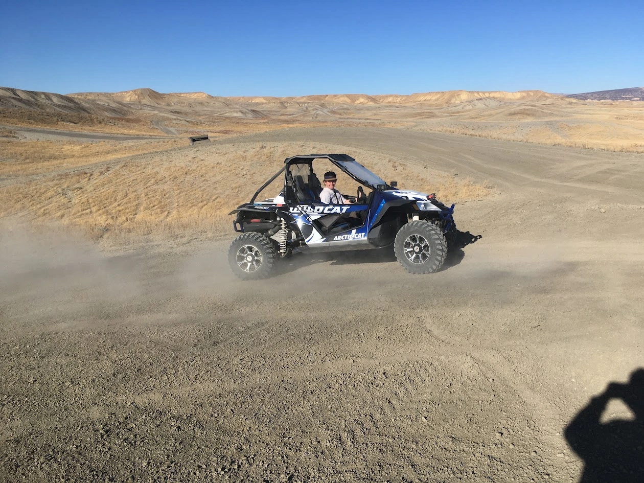 Blue side-by-side UTV speeding through the high desert near Vernal Utah