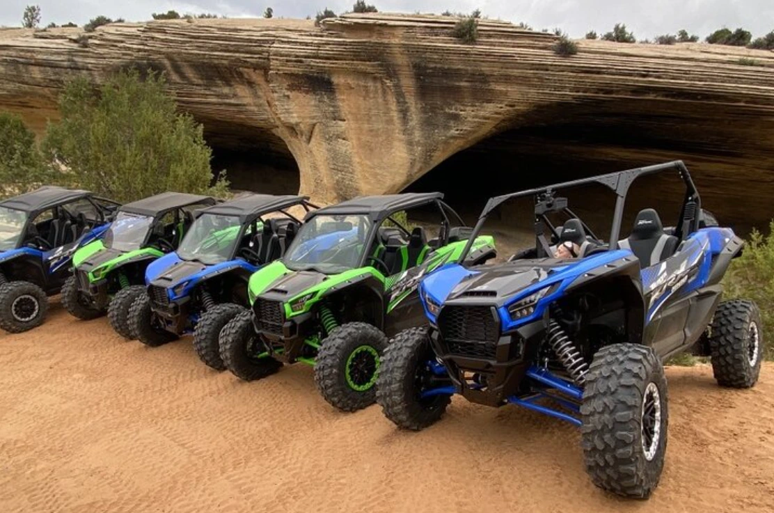 Kawasaki KRX 1000 side-by-sides lined up under a rock overhang near Vernal Utah