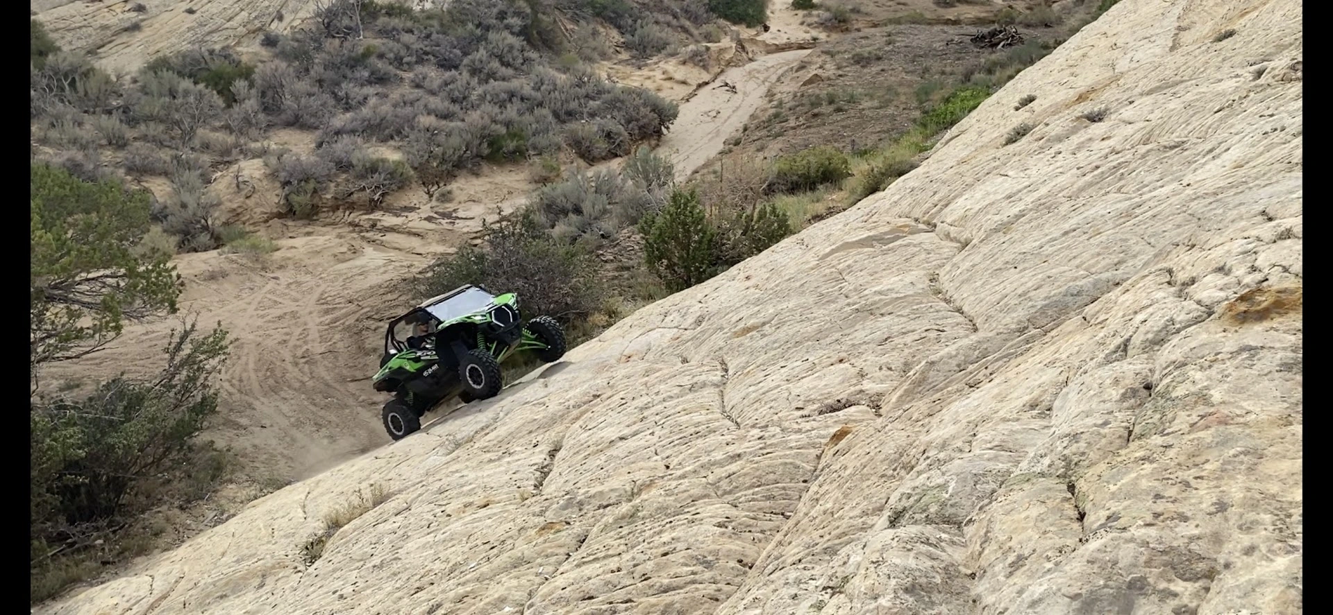 Side-by-side UTV climbing the slickrock near Vernal Utah