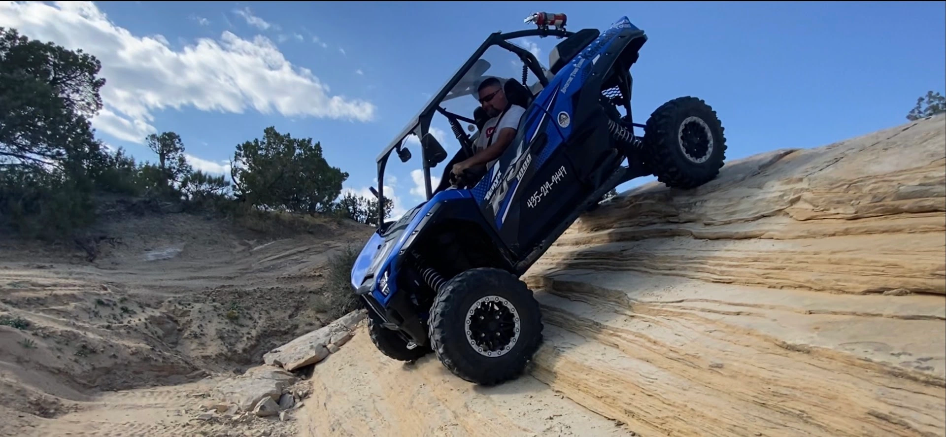 Side-by-side UTV on a steep ledge climb near Vernal Utah