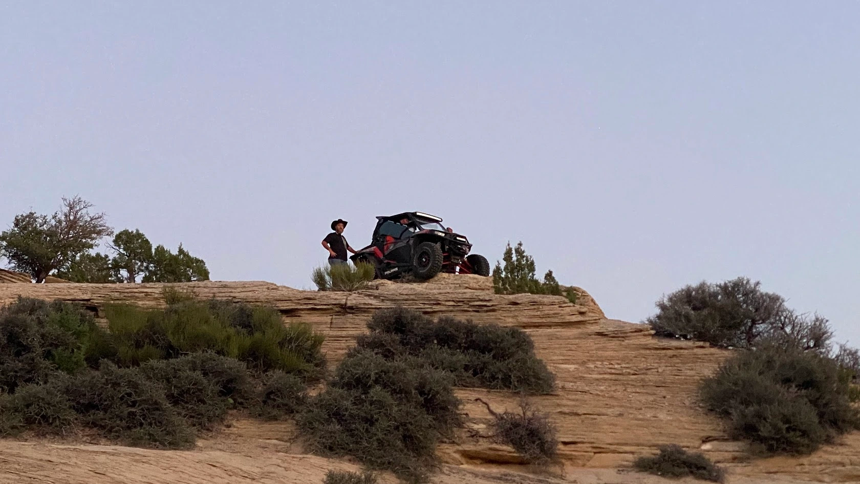 Side-by-side UTV on a ridgeline at twilight in the Utah desert backcountry